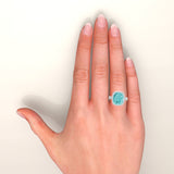 Cushion Paraiba tourmaline and diamond platinum ring on hand