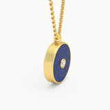 Lapis lazuli round amulet pendant side view yellow gold